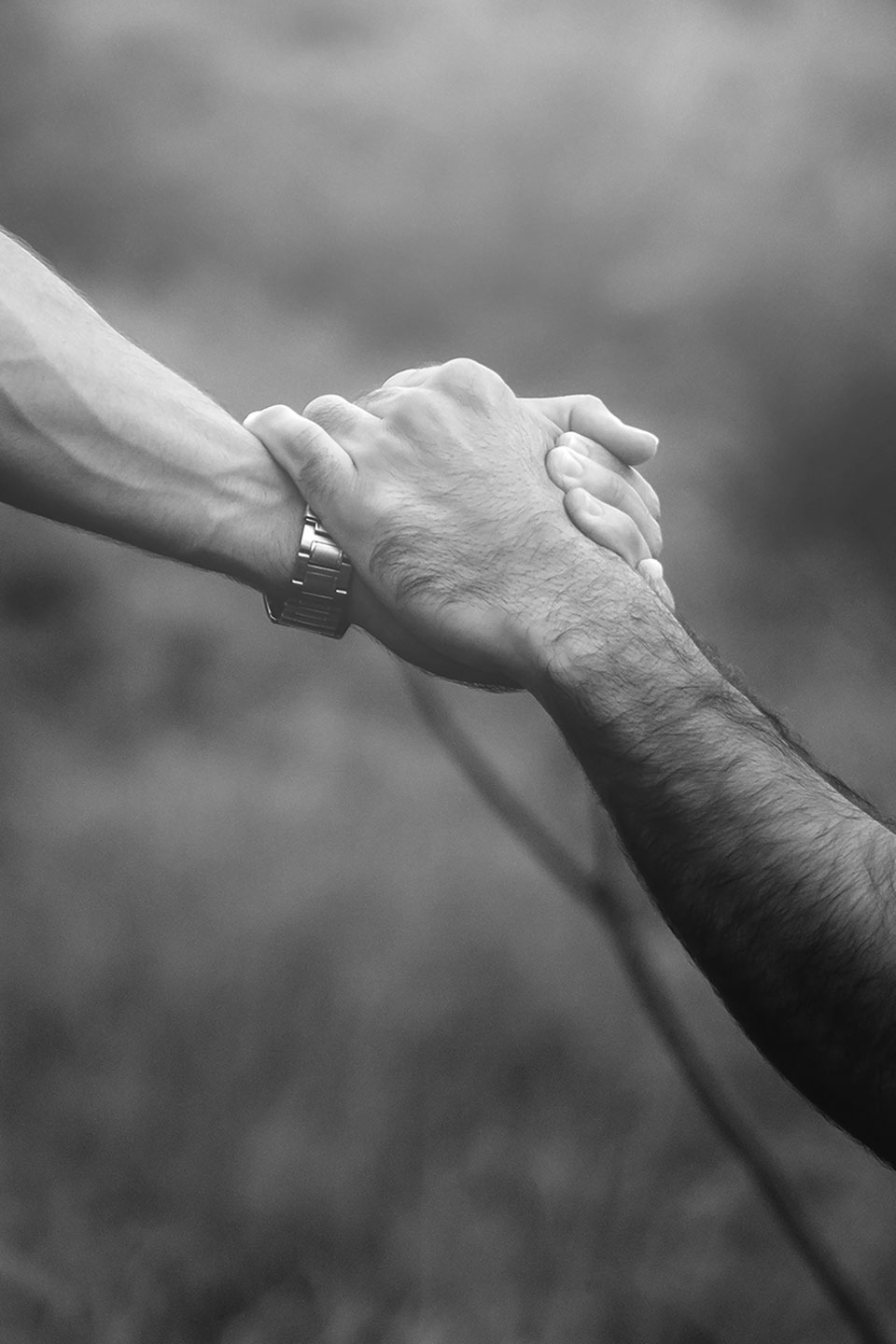Hands gripping wrists in support